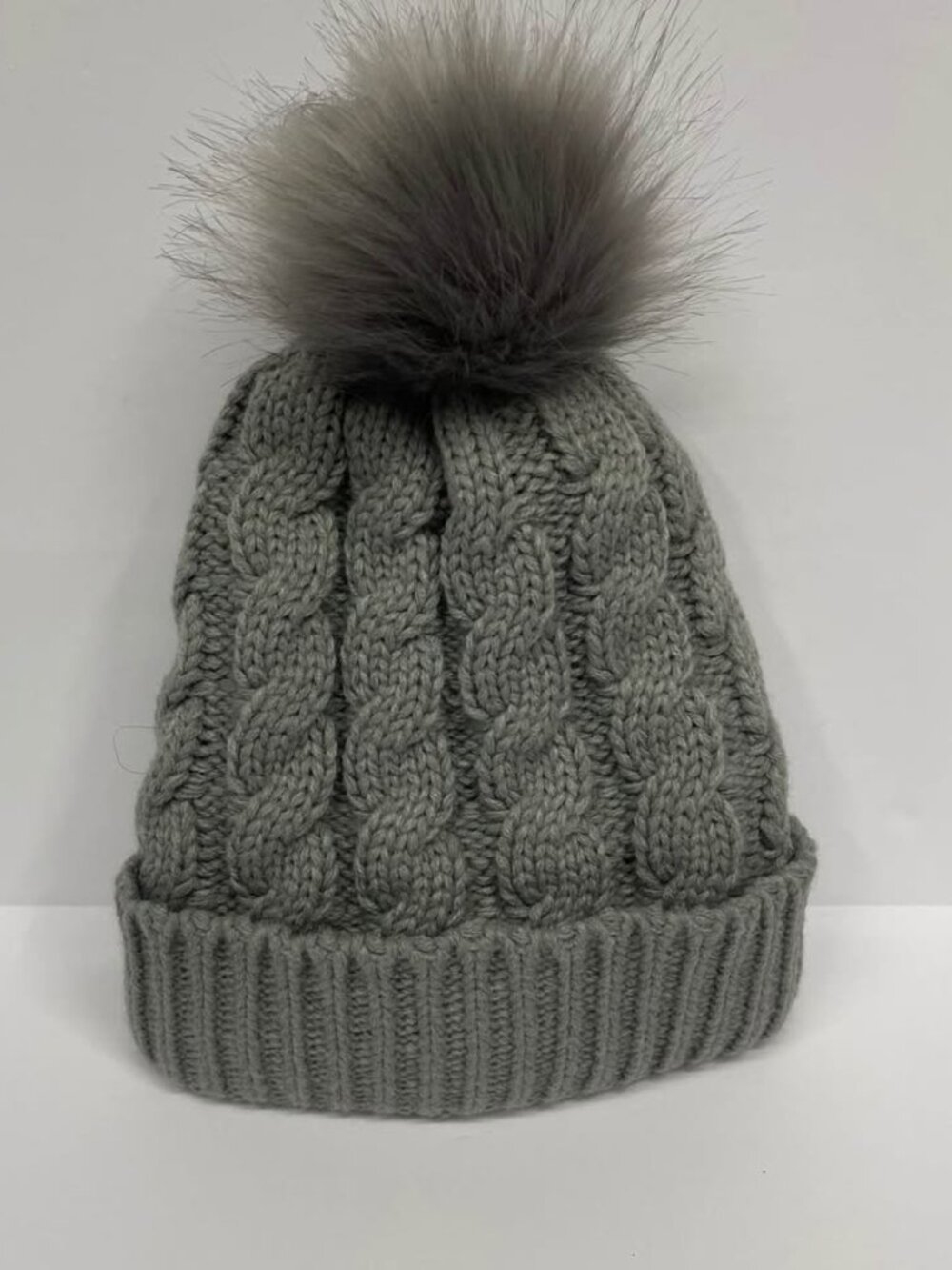 NWOT unbranded gray cable knit hat with faux fur bobble and fleece lining